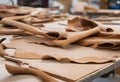Animal leather sheets stacked on a table in a product manufacturing factory.AI Generated Royalty Free Stock Photo